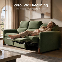 Woman reclining on a green sofa with an extended footrest.