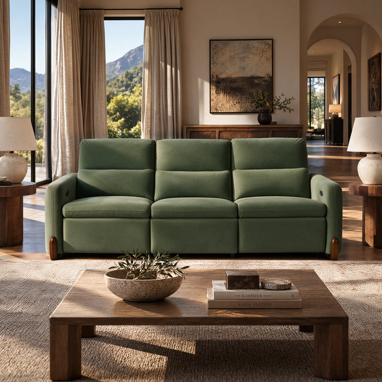 Green three-seat sofa in a sunlit living room.
