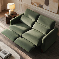 Green two-seat reclining sofa with both footrests extended in a staged living room.