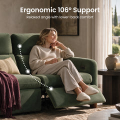 Woman seated on a green reclining sofa with the footrest extended.